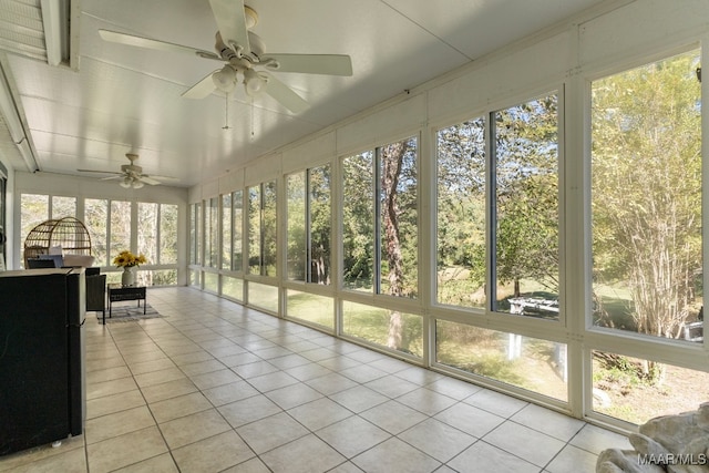 unfurnished sunroom with ceiling fan and plenty of natural light