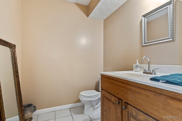 bathroom featuring vanity, a textured ceiling, toilet, and tile patterned floors