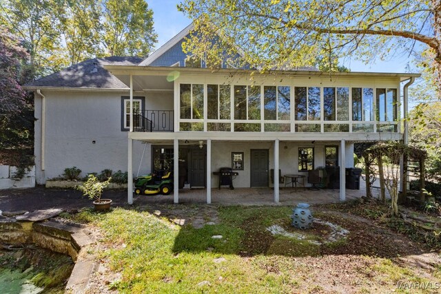 back of property with a patio and a sunroom