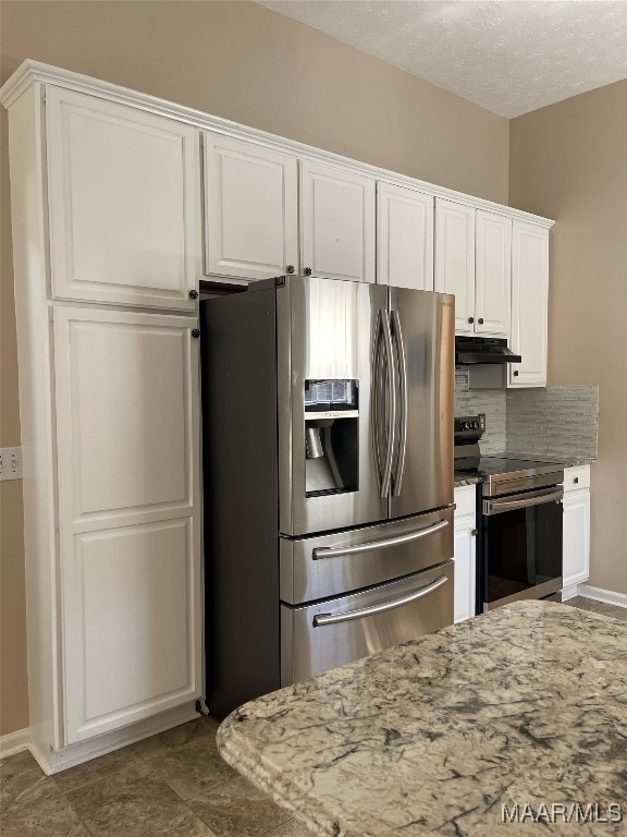 kitchen featuring backsplash, appliances with stainless steel finishes, light stone countertops, and white cabinets