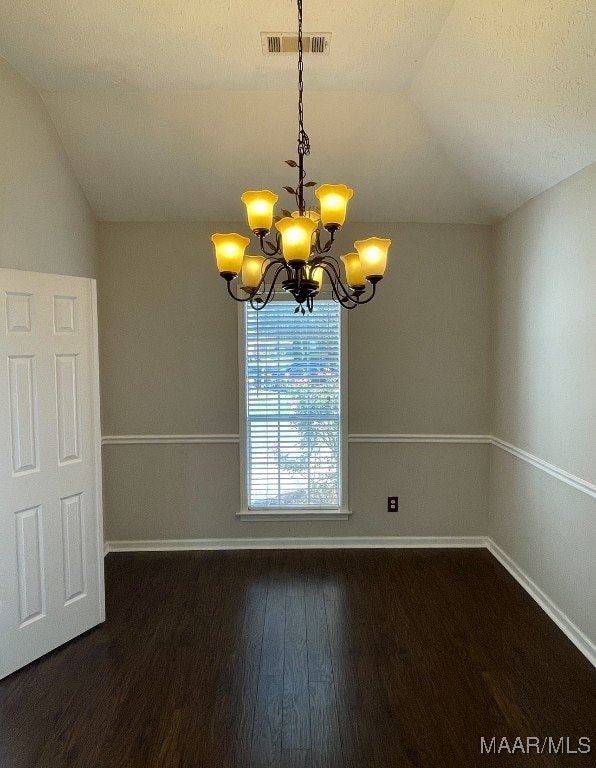 unfurnished dining area featuring lofted ceiling, a chandelier, and dark hardwood / wood-style flooring