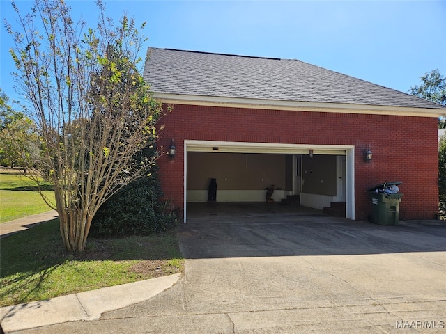 view of side of home featuring a yard and a garage