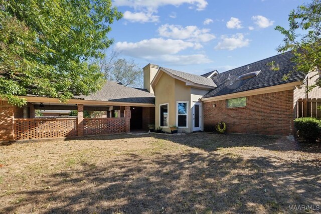 rear view of house with a yard