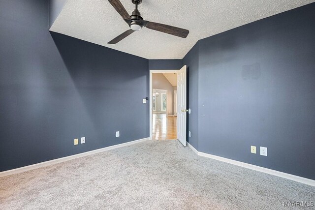 unfurnished room featuring ceiling fan, carpet flooring, and a textured ceiling