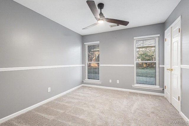 carpeted empty room with ceiling fan