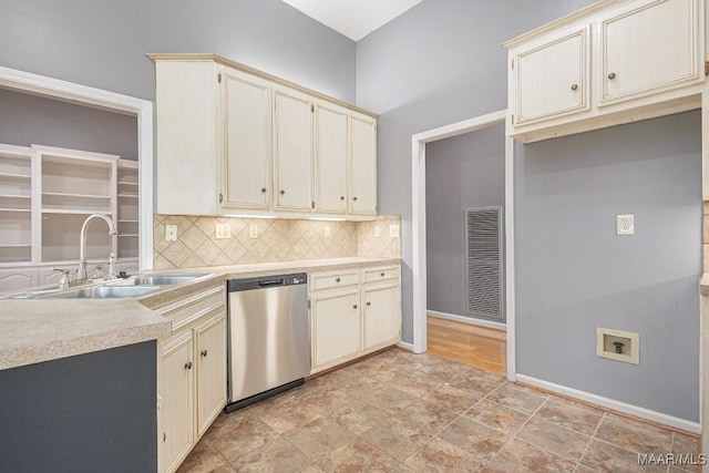 kitchen with tasteful backsplash, sink, cream cabinets, and dishwasher