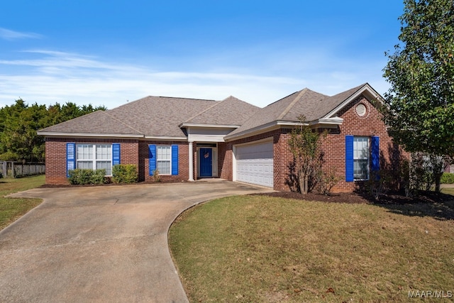 ranch-style home featuring a front yard and a garage