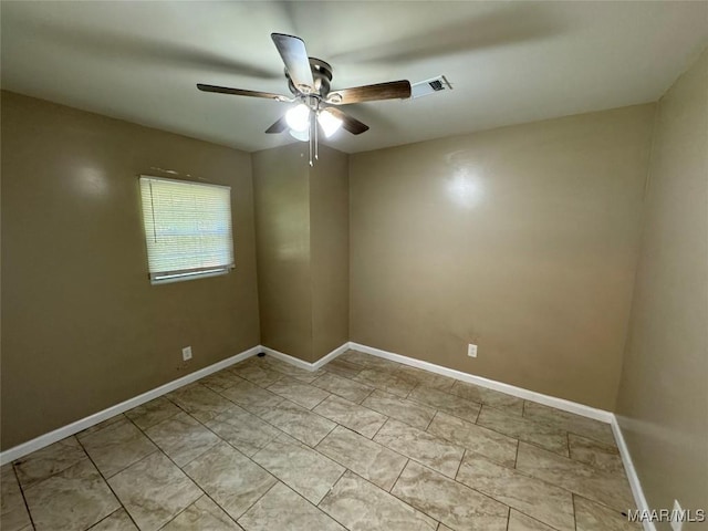 unfurnished room featuring a ceiling fan and baseboards