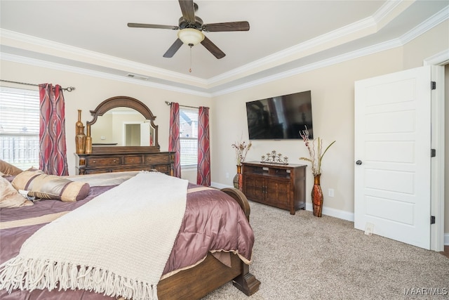 bedroom with crown molding, light colored carpet, a raised ceiling, and ceiling fan