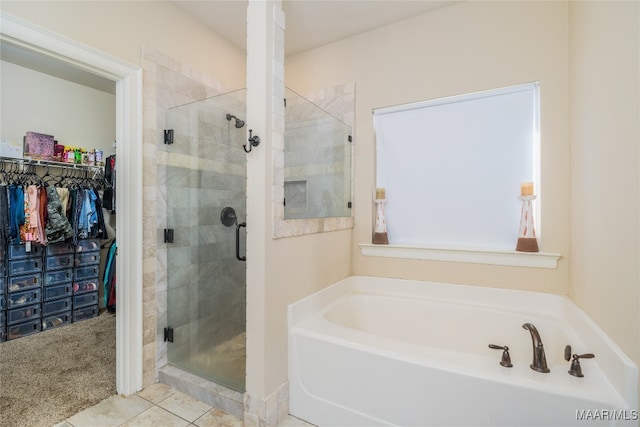 bathroom with independent shower and bath and tile patterned flooring