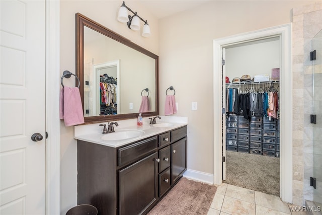 bathroom with vanity, tile patterned floors, and a shower with shower door