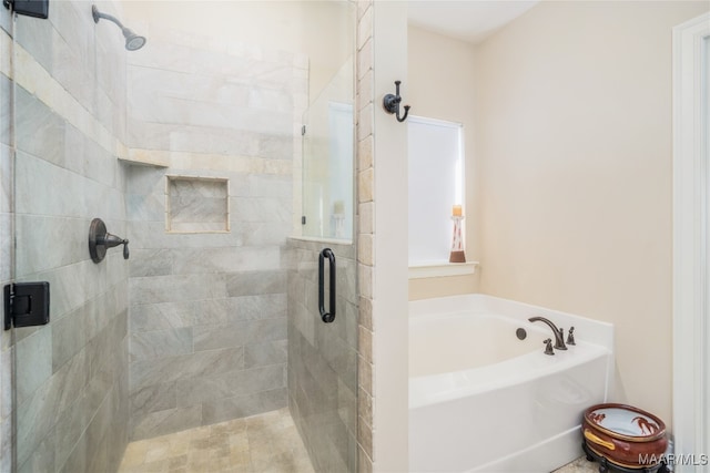 bathroom featuring shower with separate bathtub