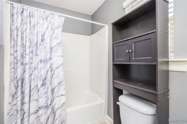 bathroom with shower / tub combo with curtain and toilet