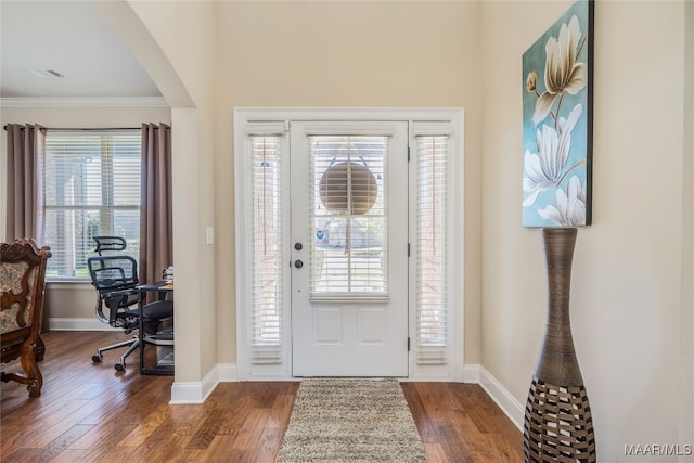 foyer featuring hardwood / wood-style floors and crown molding