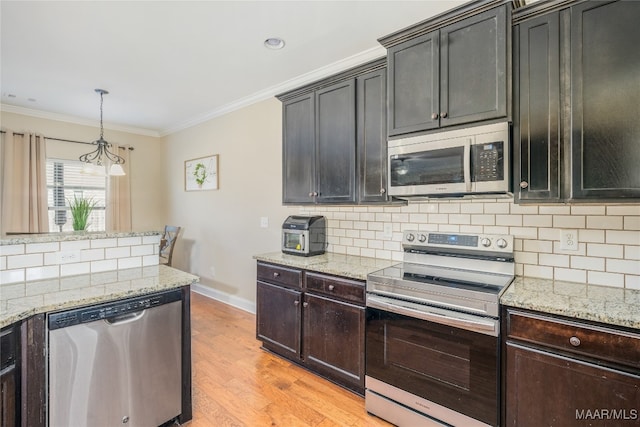 kitchen featuring decorative backsplash, stainless steel appliances, light stone counters, ornamental molding, and light hardwood / wood-style flooring