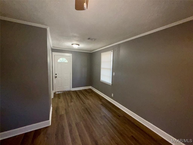 entryway with ornamental molding and dark hardwood / wood-style flooring