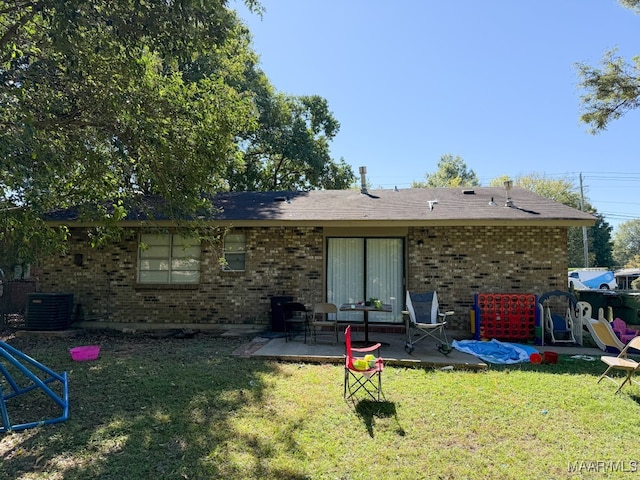 back of property with a patio, central air condition unit, and a lawn