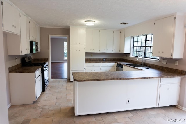 kitchen with kitchen peninsula, stainless steel appliances, and white cabinetry