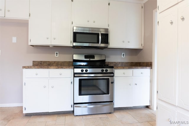 kitchen featuring white cabinetry, appliances with stainless steel finishes, and light tile patterned floors