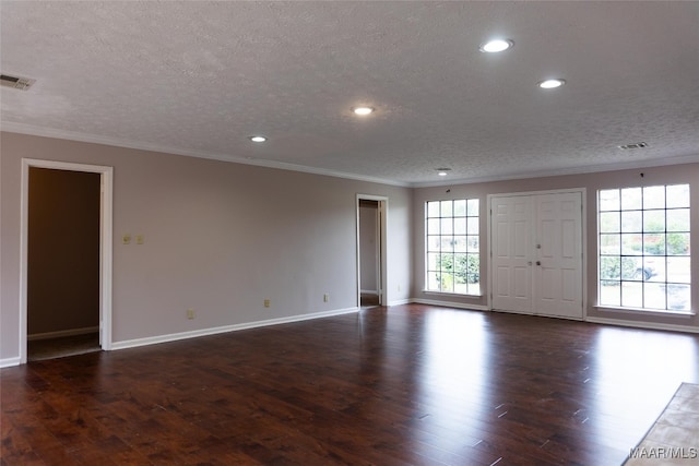 unfurnished room with crown molding, dark hardwood / wood-style flooring, and a textured ceiling