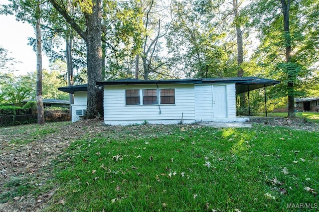 view of outdoor structure featuring a lawn and a carport