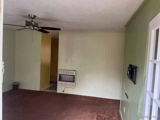 carpeted empty room featuring a textured ceiling, heating unit, and ceiling fan