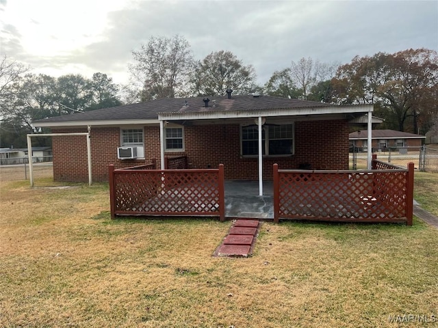 rear view of house featuring a lawn, a patio area, and cooling unit