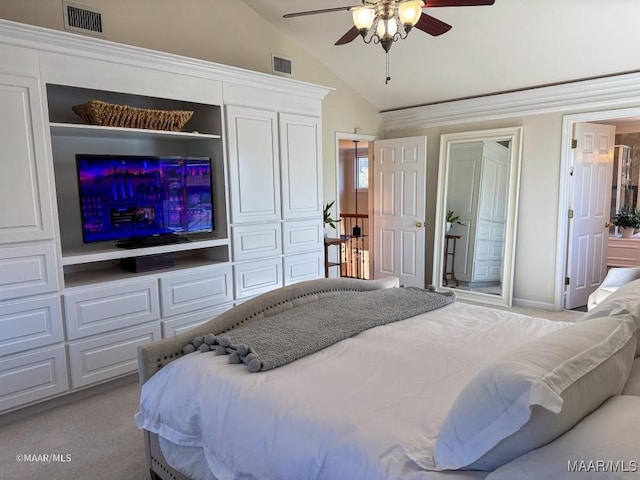carpeted bedroom featuring visible vents, a ceiling fan, and lofted ceiling