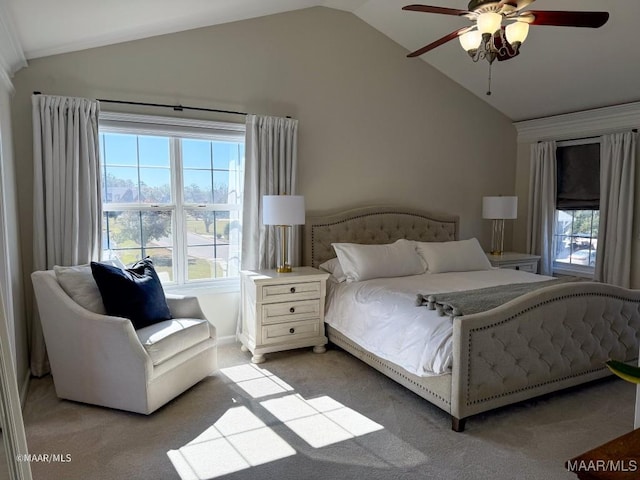 bedroom featuring ceiling fan, light carpet, multiple windows, and lofted ceiling