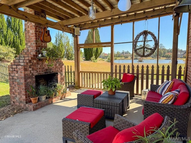 view of patio featuring an outdoor living space with a fireplace and a water view