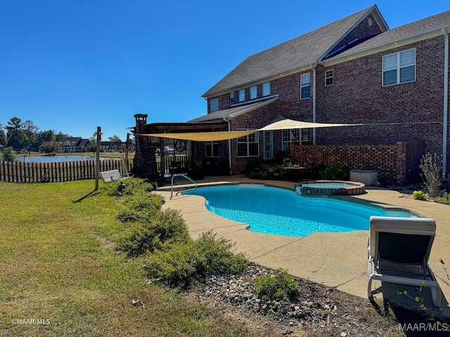 view of pool featuring an in ground hot tub, a yard, and a patio