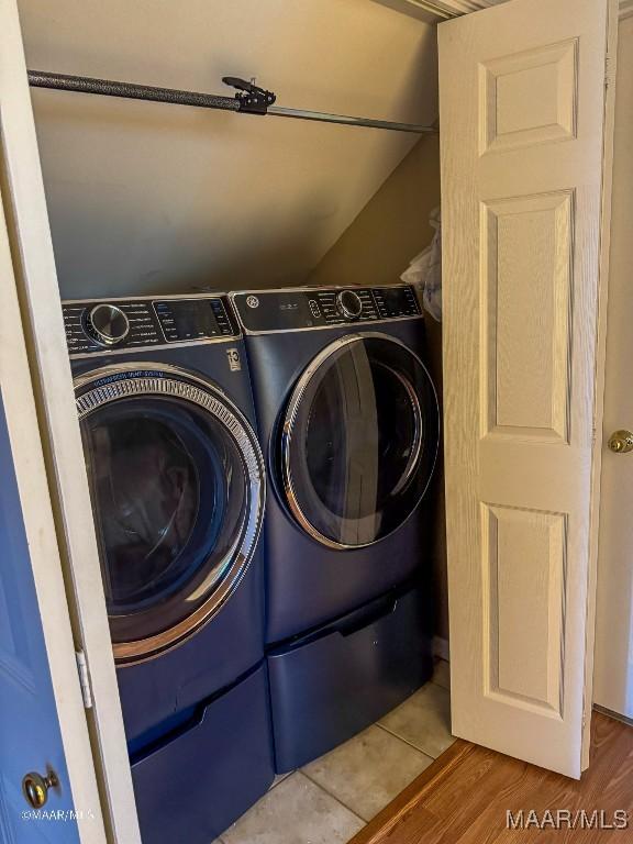 clothes washing area featuring independent washer and dryer and hardwood / wood-style flooring