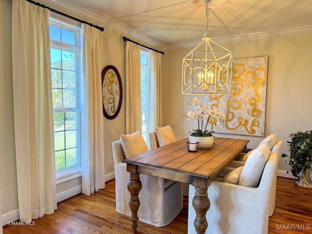 dining space with a notable chandelier, a wealth of natural light, and wood finished floors