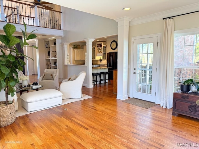 living room with recessed lighting, ornamental molding, decorative columns, wood finished floors, and a ceiling fan