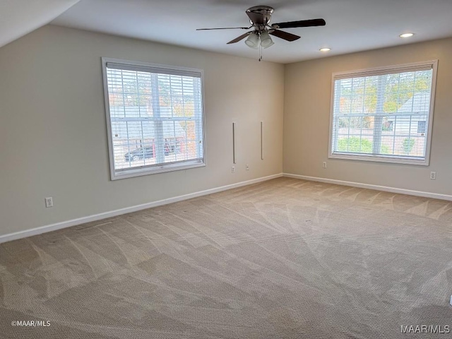 spare room with light carpet, ceiling fan, and lofted ceiling