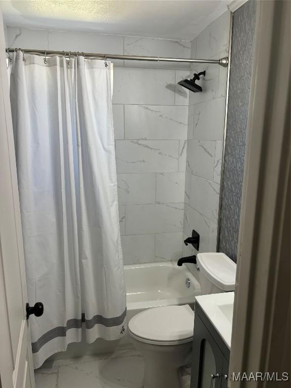 full bathroom featuring vanity, shower / tub combo, and toilet