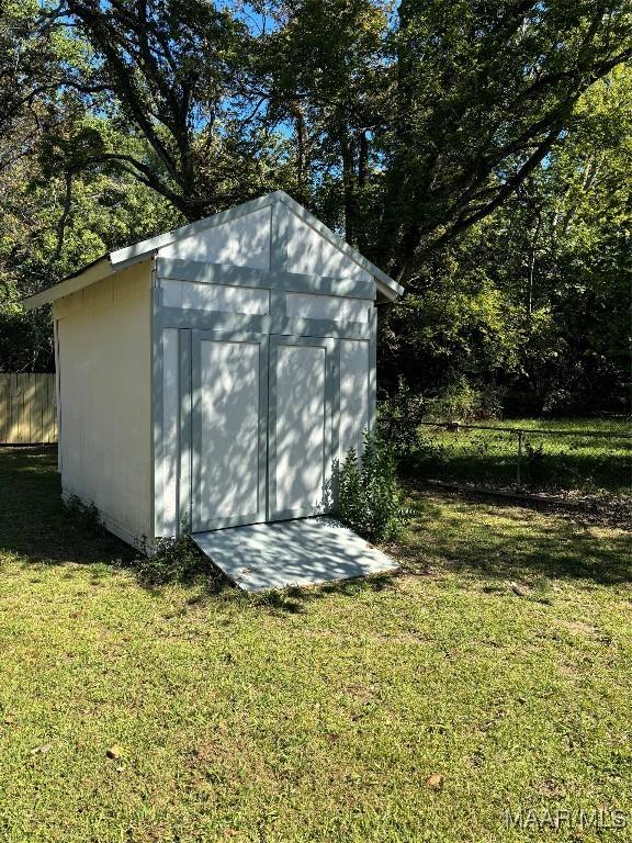 view of outbuilding featuring a lawn