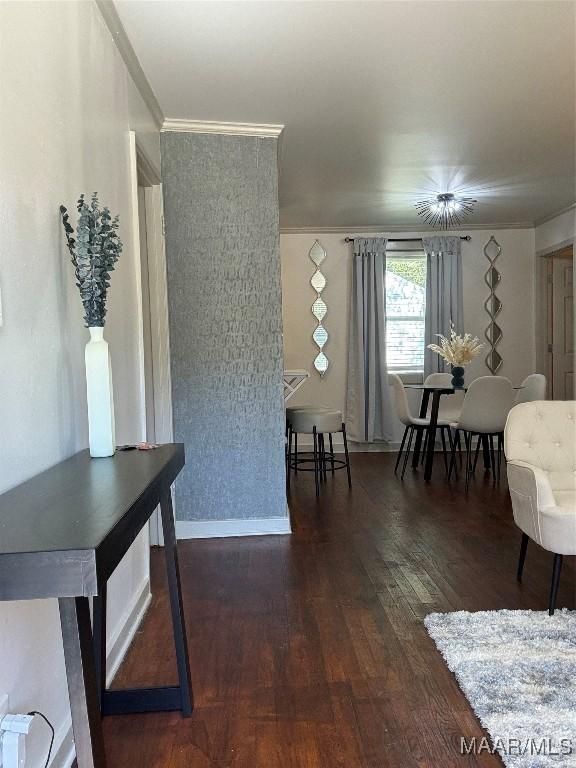 interior space with dark hardwood / wood-style flooring, an inviting chandelier, and crown molding