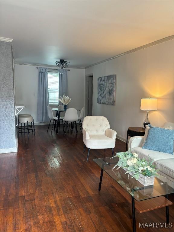 living room with dark hardwood / wood-style floors and ornamental molding