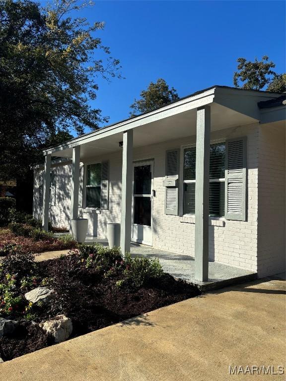 view of side of property with covered porch