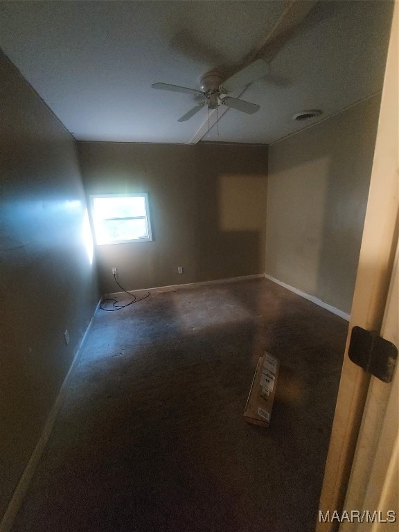 carpeted spare room with ceiling fan