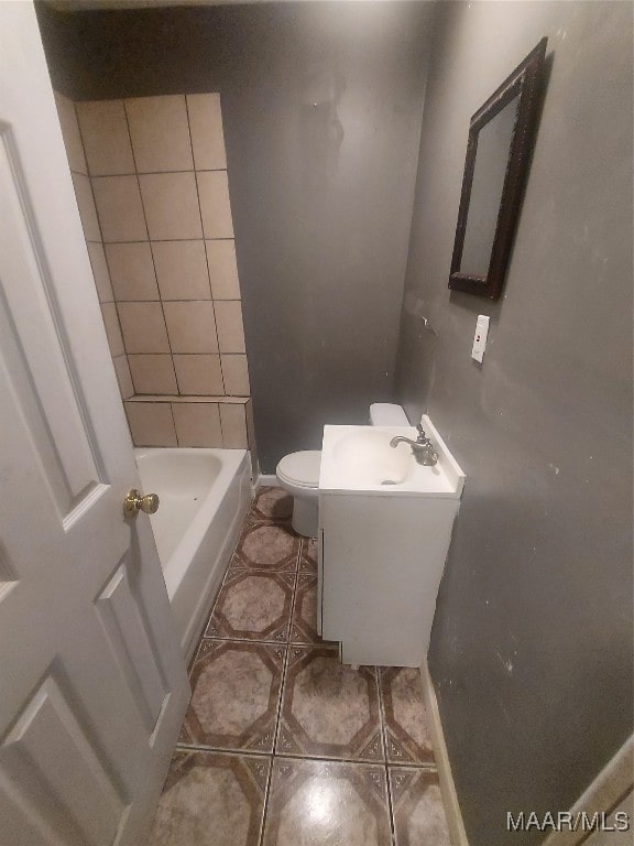 bathroom with a bathtub, toilet, tile patterned flooring, and vanity