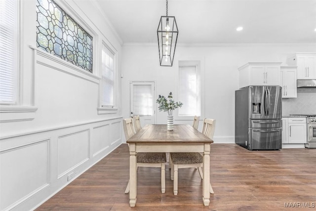 dining room featuring recessed lighting, dark wood-type flooring, and crown molding