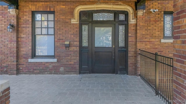 doorway to property with brick siding