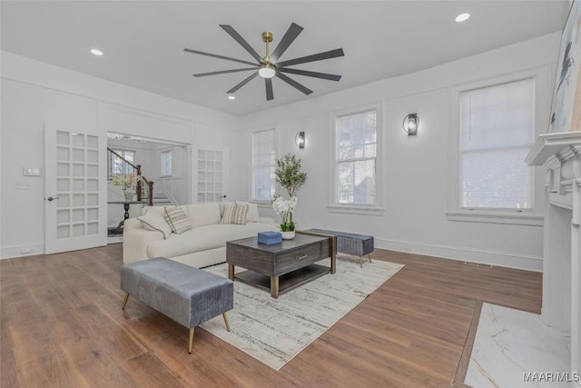 living area with baseboards, a ceiling fan, wood finished floors, and recessed lighting