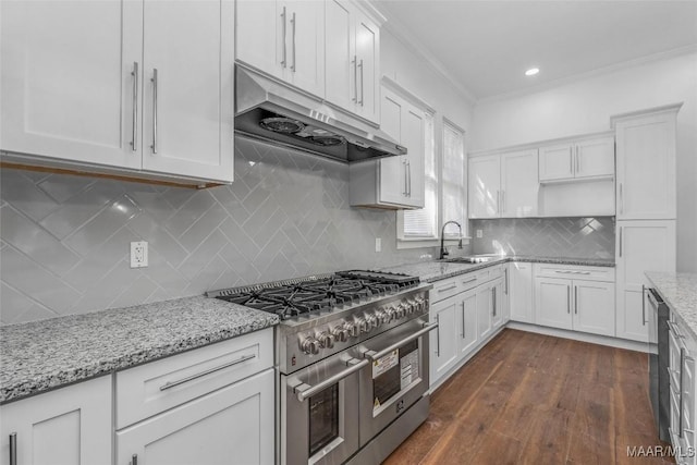 kitchen with a sink, under cabinet range hood, double oven range, white cabinetry, and dark wood-style floors