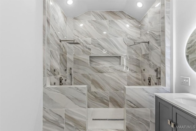 bathroom featuring recessed lighting, walk in shower, lofted ceiling, and vanity