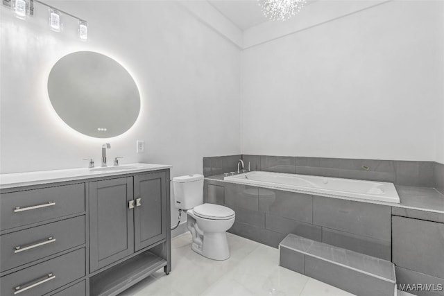 bathroom with a bath, vanity, and toilet