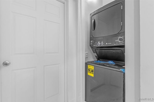 washroom with stacked washer / dryer and laundry area
