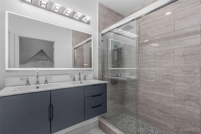 bathroom featuring a sink, double vanity, and a stall shower